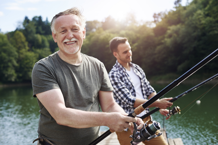 adult son fishing with dad to celebrate Father's Day