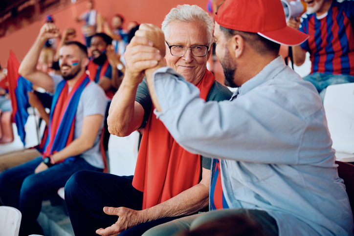 adult son sharing a sporting event with dad on Father's Day